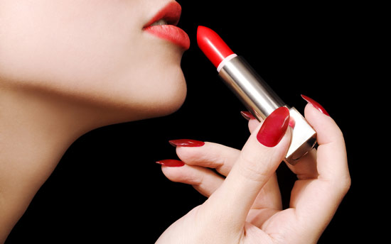 applying red lipstick