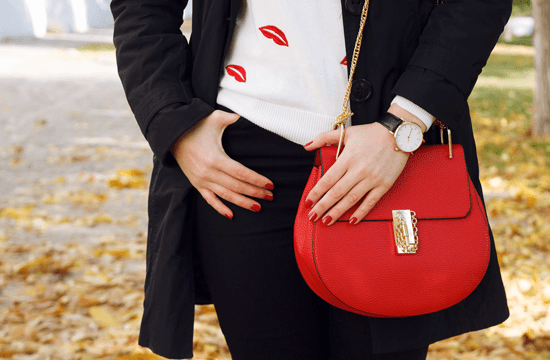 red handbag with gold embellishment
