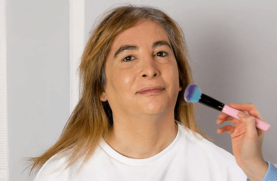 transwoman putting on makeup