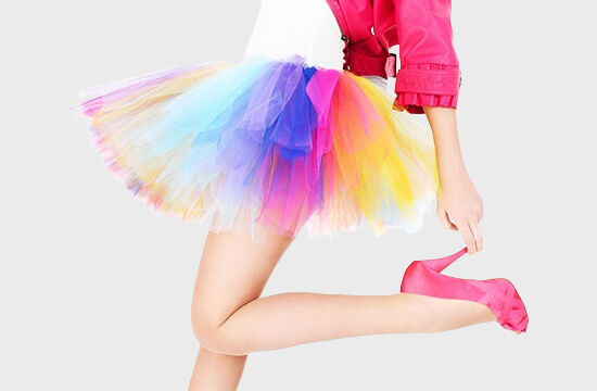 woman in colorful skirt and pink heels